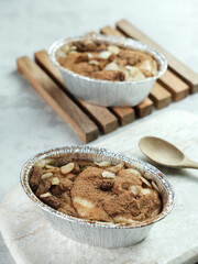 Klappertaart, Indonesian traditional dessert, from Manado. Coconut custard cake with raisin and almond topping, dusted with cinnamon powder, Dutch influenced dessert. 
