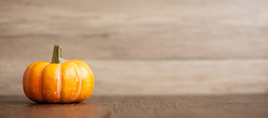 Orange pumpkin on table with copy space for banner background. Happy Halloween day, Hello October,...