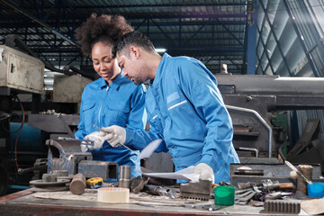 Two professional industry workers teams in safety uniforms and engineers' partners worked with metalwork tools, checked mechanical precision for lathe machines, and workshops in manufacturing factory.