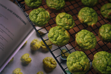 ready-made small green muffins with spinach on a baking sheet