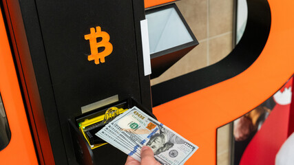Atm cash bitcoin teller machine. Woman withdraw american dollar bill money. Usd hundred money payment on virtual crypto currency btc wallet. Bitcoin BTC ATM Cash Machine.