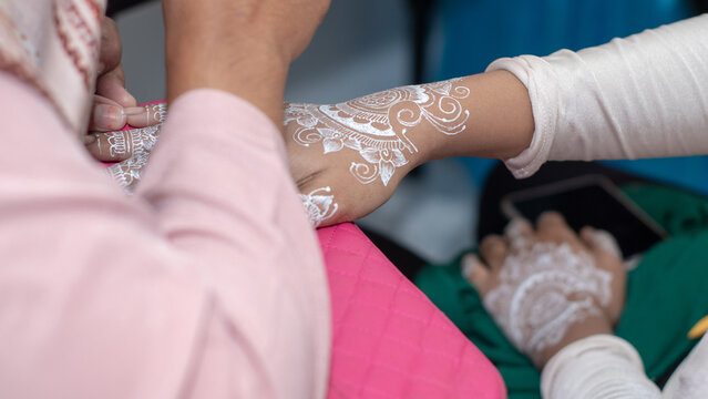 jakarta, indonesia - July, 2022 - henna tattoo painted on the bride's hand