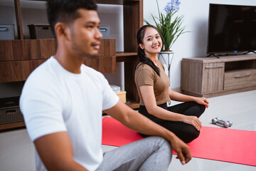 portrait of muslim beautiful woman and husband doing fun exercise at home