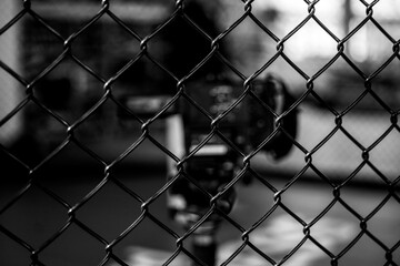 A video camera behind a fence wire