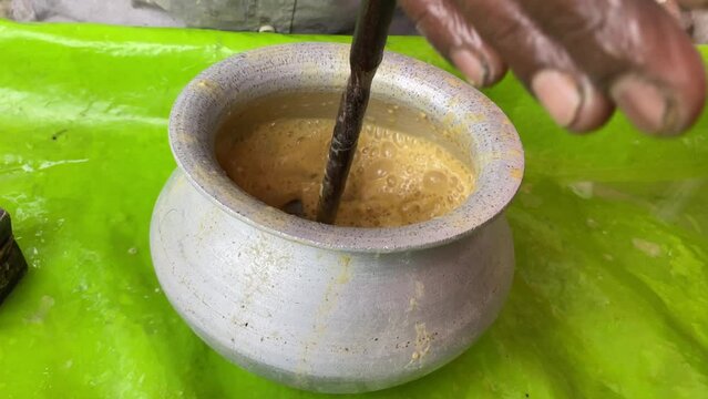 Video of a man preparing Sattu Sharbat, a summertime beverage prepared with roasted black chickpea flour, sugar, and water. No face video