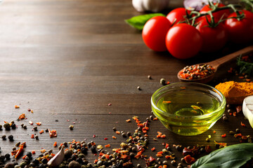 Different cooking ingredients and spices on wooden background