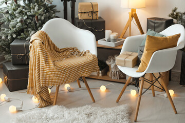 Warm and cozy interior in Scandinavian house during winter holidays with Christmas tree and gifts