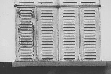 white window with shutters