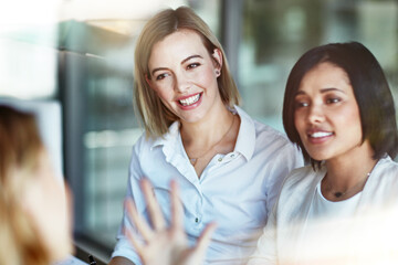 Business people talking, discussing and making conversation in a meeting, seminar or training in an office together at work. Colleagues, employees and professionals smiling while having a discussion