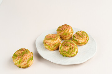 Choux pastry contains butter, water, flour, and eggs. Choux pastries are sometimes filled with cream to make cream puffs. 
