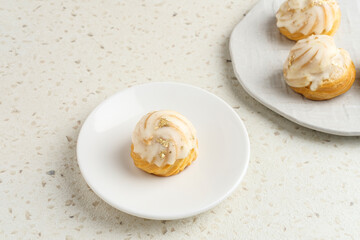 Choux pastry contains butter, water, flour, and eggs. Colorful choux with chocolate glaze.