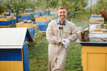 A tools of the beekeeper. Everything for a beekeeper to work with bees. Smoker, a chisel, a box, beekeeper suit for protection from the bees, equipment for beekeeping, beekeeping concept