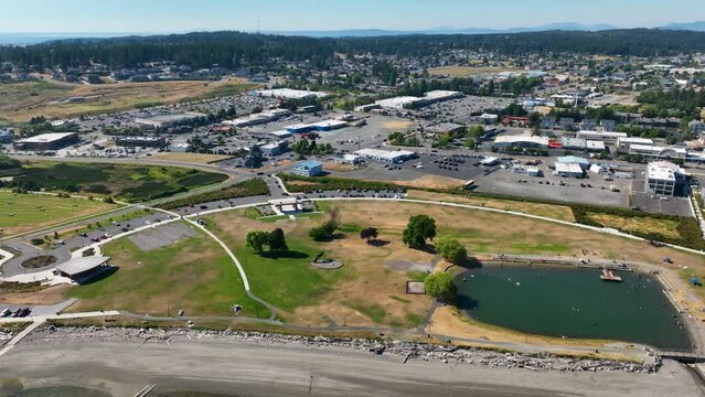 Aerial of the Windjammer Park swimming lagoon with the main shopping centers in the distance in Oak Harbor, WA.