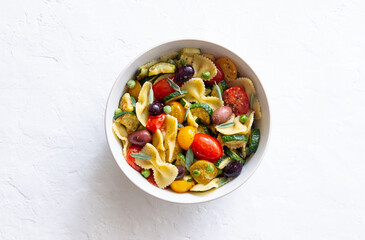 Pasta farfalle with tomatoes, zucchini, peas, Kalamata olives and sage. Healthy eating. Vegetarian food.