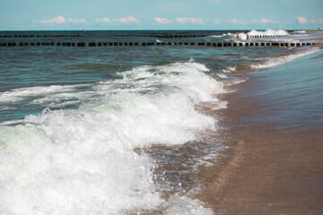 Splashes of fresh foaming, bubbling sea water, mad whirlpool waves, white crest of waves, Sandy coast of Baltic Sea, Poland.