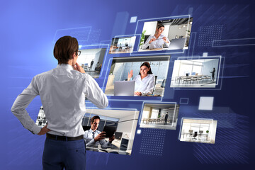 Back view of attractive young european businessman looking at creative digital picture gallery on...