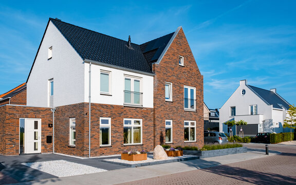 Dutch Suburban area with modern family houses, newly build modern family homes in the Netherlands, dutch family houses in the Netherlands, newly build streets with modern houses. 