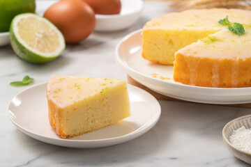 Delicious Lemon Glazed Pound Sponge cake on white marble table background.