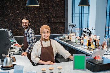 muslim waitress or owner and partner portrait smiling to camera at the coffee shop