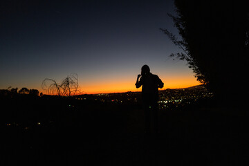 silhouette of person against gorgeous sunset in canyon of Los Angeles, CA