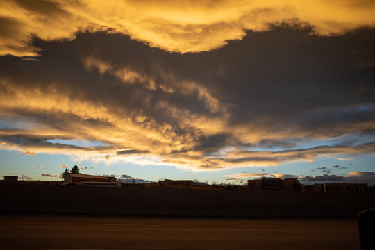dramatic ominous storm clouds form at sunset over sparse landscape