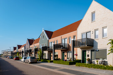 Dutch Suburban area with modern family houses, newly build modern family homes in the Netherlands, dutch family houses in the Netherlands, newly build streets with modern houses.  - obrazy, fototapety, plakaty