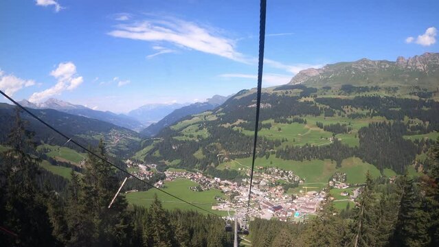 Cable car ride in canton Grisons Churwalden. The gondola lift descends into the valley. You can see masts of the cable railroad