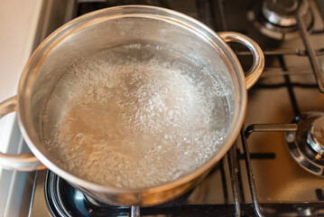 Boiling water inside a pot.Kitchen iron pot,top view,selective focus.