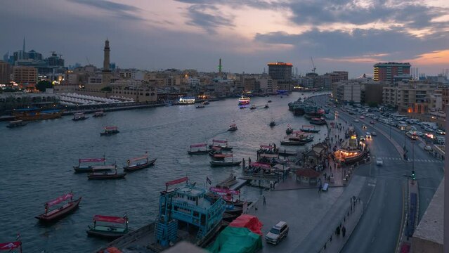 Day to night Time lapse of boats or abras taking commuters crossing in Dubai creek