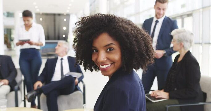 Beautiful, young and confident business woman smiling in a meeting during a professional conference, seminar or convention. Planning for success, talking and discussing strategy with her work team