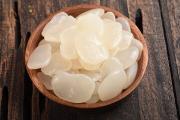 sugar palm fruit or kolang kaling in wooden bowl on wooden background .
