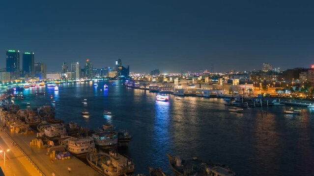 Time lapse of boats or abras sailing at night in Dubai creek