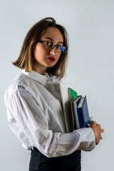 woman in business style  books in hands smiling on isolated white studio background.