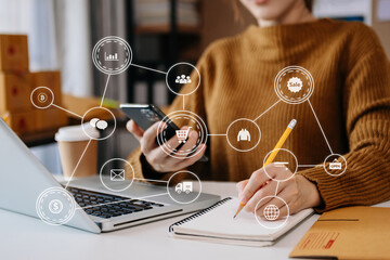  Woman hand using laptop, smartphone and tablet and writing notebook at office of her business online shopping. In home .