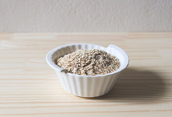 oat or granola in white bowl, ready for cooking. Healthy food  concept.