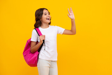School girl in school uniform with school bag. Schoolchild teenager hold backpack on yellow isolated background.