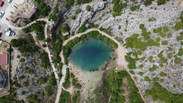 top view of the crystal clear turquoise deep blue cetina spring in croatia, well known instagram hot spot