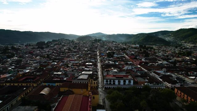 drone shot in reverse showing sunrise over the main square and town of san cristobal de las casa in chiapas, mexico