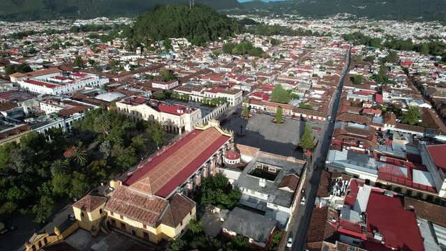 drone shot turning and showing sunrise over the main square and town of san cristobal de las casa in chiapas, mexico