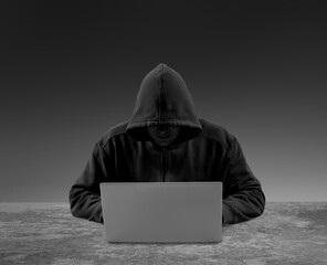 Computer hacker stealing data from a laptop for network security, identity theft and computer crime