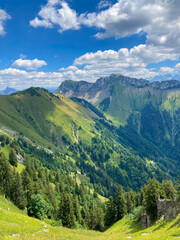 Fototapeta premium Montreux, Switzerland: 01-08-2022: Panorama of the Switzerland Alpine mountains. Ridges, peaks and lake are visible in the background. Beautiful view in the French Canton.