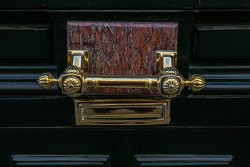 Antique handle on a door in the center of Paris.