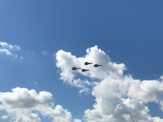 Military aircraft fighter jets fly in the blue sky without clouds performing different tactical...