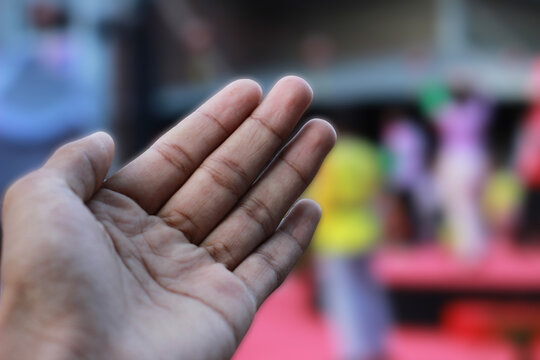 man's left hand on a blurred background