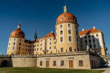 Fototapeta na wymiar View of fairy tale Moritzburg Castle in Saxony,Germany.Magnificent baroque palace in middle of large pond and park.Popular location for Czech fairy tale movie Three Nuts for Cinderella.
