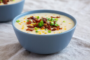Homemade Corn Chowder with Bacon in Bowls, side view. Close-up.
