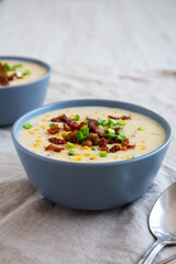 Homemade Corn Chowder with Bacon in Bowls, side view.