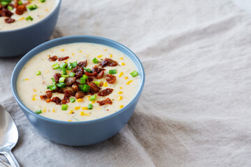 Homemade Corn Chowder with Bacon in Bowls, side view. Space for text.
