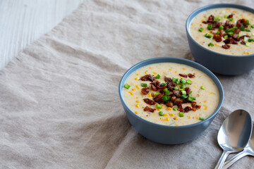 Homemade Corn Chowder with Bacon in Bowls, side view. Copy space.