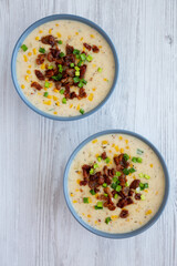 Homemade Corn Chowder with Bacon in a Bowl on a white wooden background, top view. Flat lay, overhead, from above.